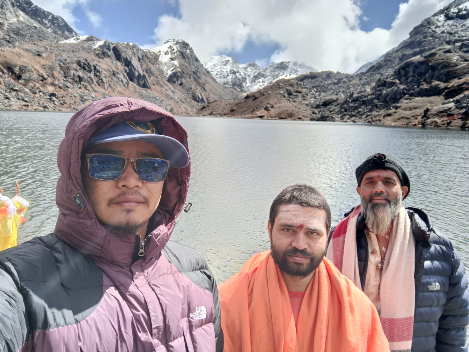 Trekkers at a sacred alpine lake in the Himalayas of Nepal