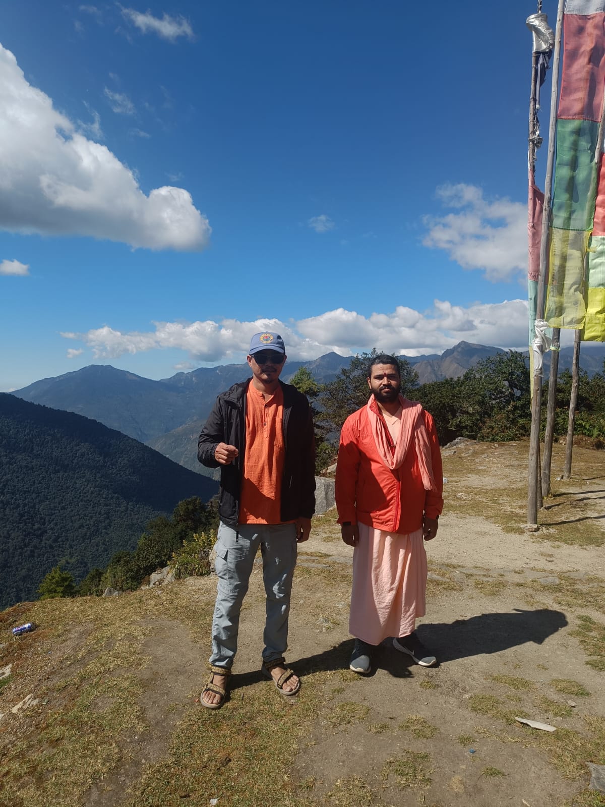 Yogis on a Himalayan mountain trail with prayer flags, Nepal