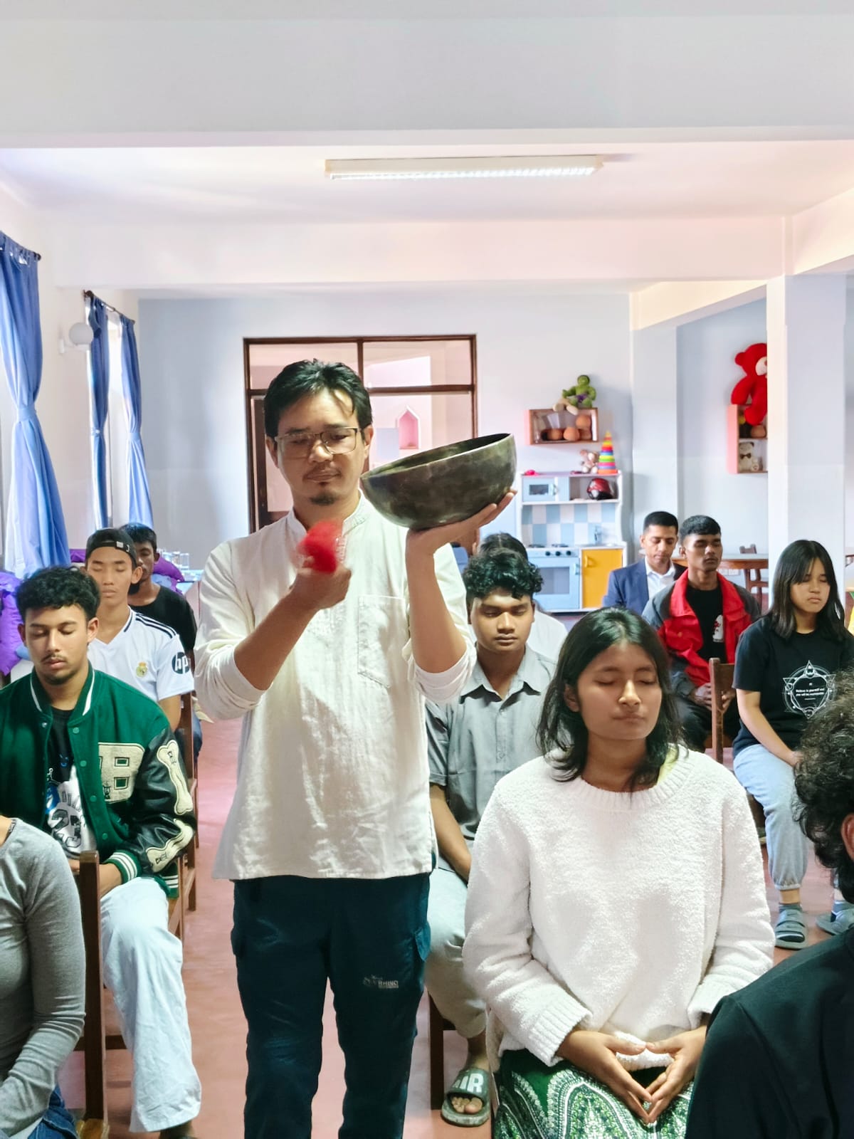 Himalayan singing bowl sound meditation session with students in Kathmandu