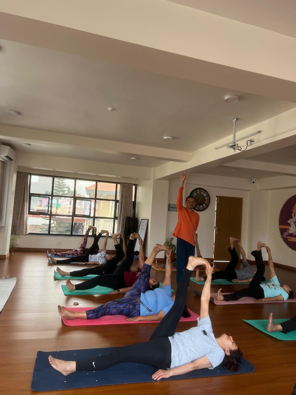 Students practising Hatha yoga asana in a daily class at Yogmandu studio, Kathmandu