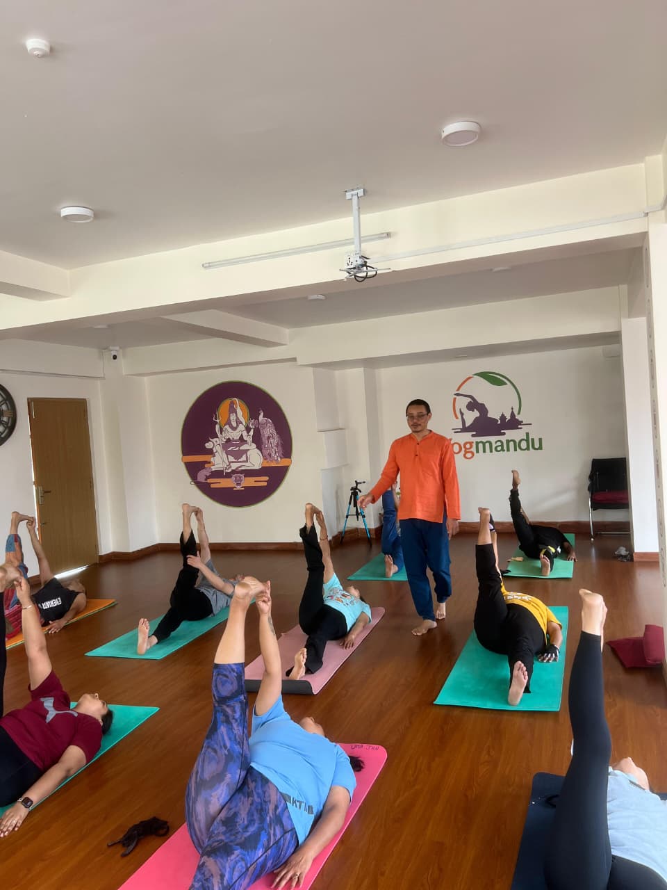 Students practising Hatha yoga asana in a daily class at Yogmandu studio in Kathmandu, Nepal