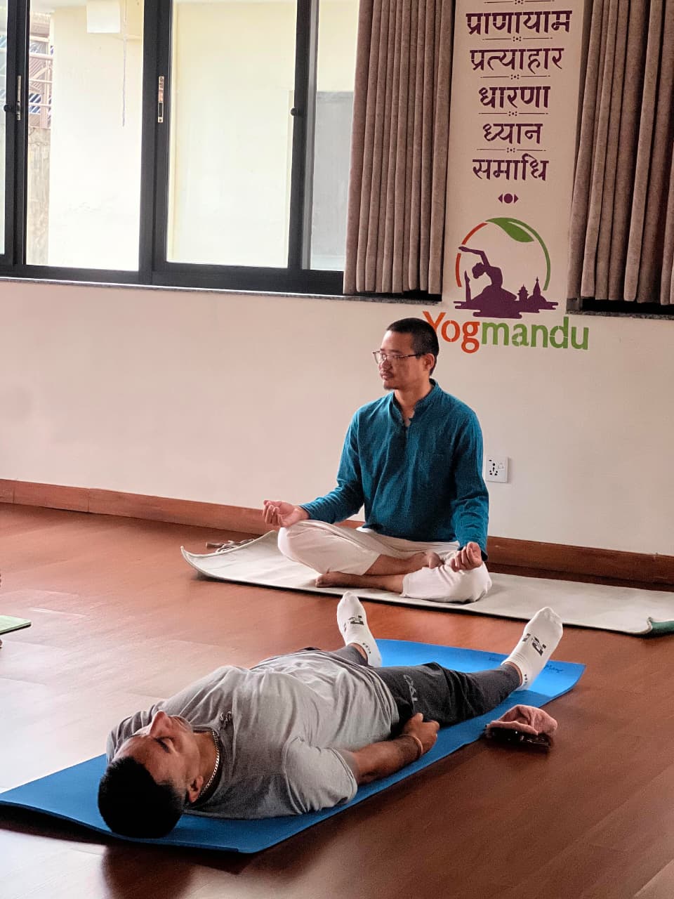 Alignment guidance during an asana class at Yogmandu yoga studio in Nepal