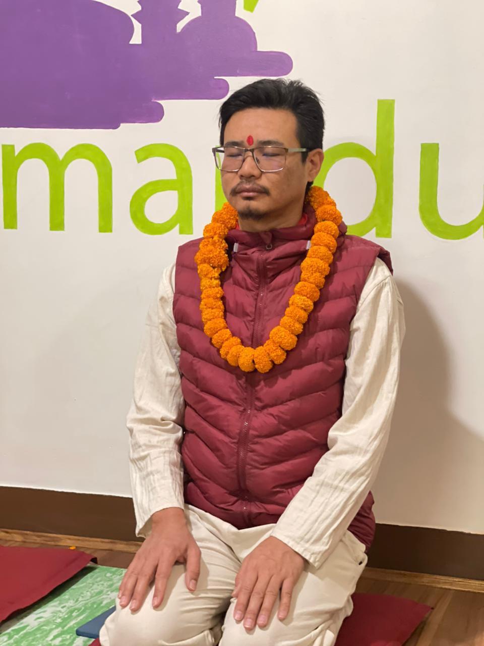 Student honoured with a marigold garland at Yogmandu yoga school in Kathmandu