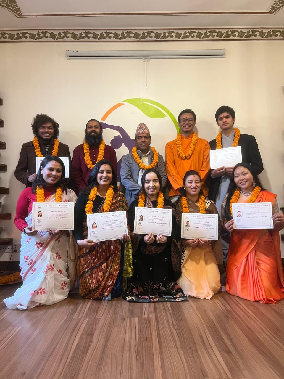 Yoga teacher training graduates with certificates and marigold garlands at Yogmandu school, Kathmandu