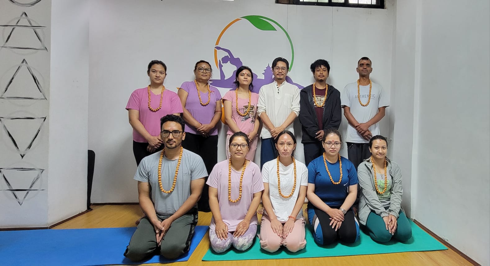 Students seated in namaste after a pranayama and meditation session at Yogmandu